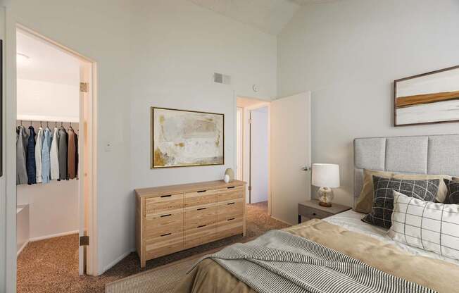 A bedroom with a bed, nightstand, and a painting on the wall.