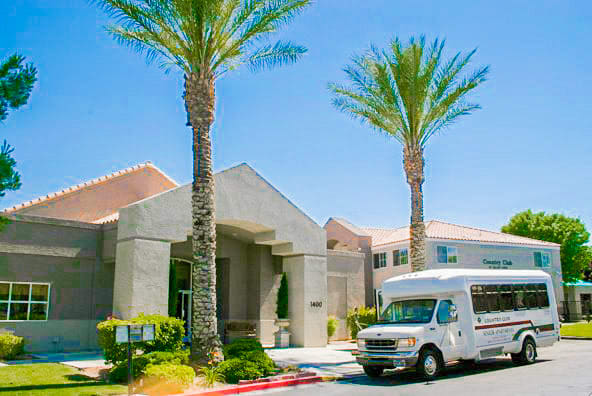 a white van parked in front of a building with palm trees