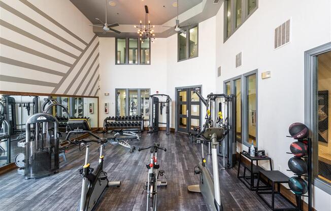 a gym with weights and other exercise equipment in a large room