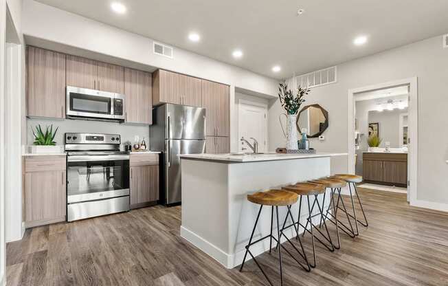 A modern kitchen with a bar stool.