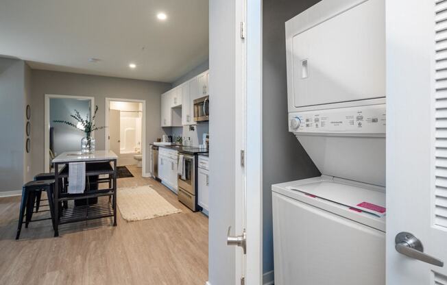 a kitchen and dining room with a refrigerator and a table