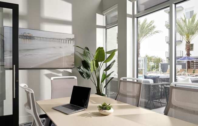 a conference room with a laptop on a table