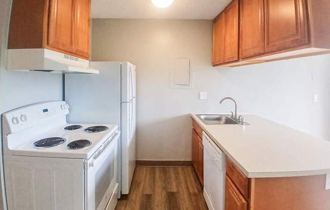 A white stove and oven in a kitchen with wooden cabinets.
