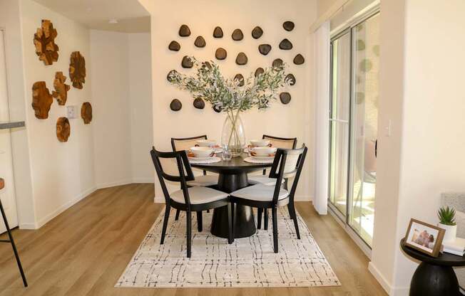 A dining room with a table set for four.