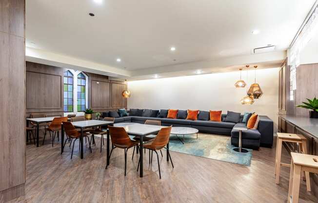 a living room with couches and tables and chairs