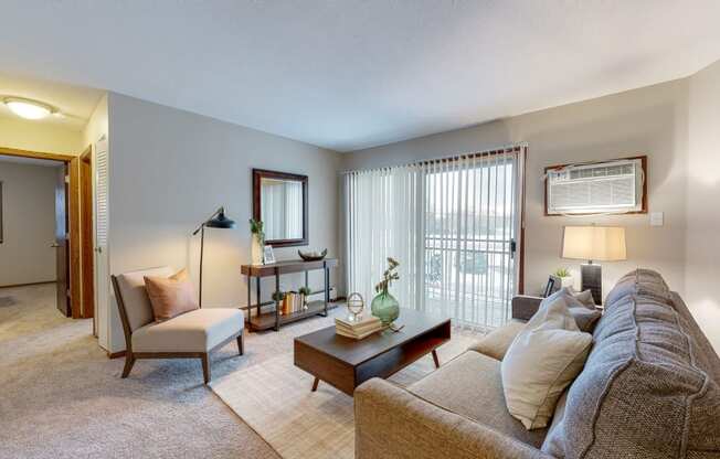 a living room with a couch chair and coffee table