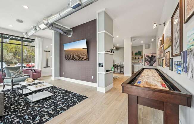 a game room with a pool table and a tv at The Quarry Luxury Apartment Homes, Fort Collins