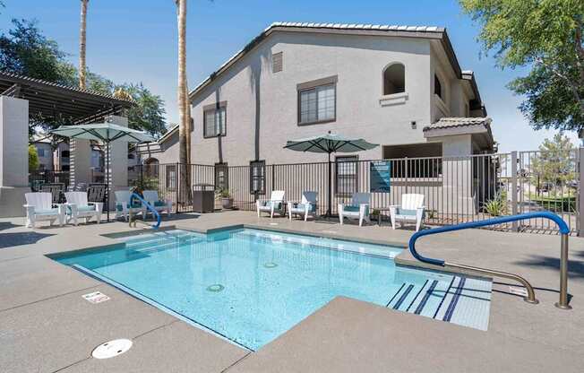 A swimming pool in front of a house with a blue tiled edge. at Lazo Apartment Homes, Arizona, 85225