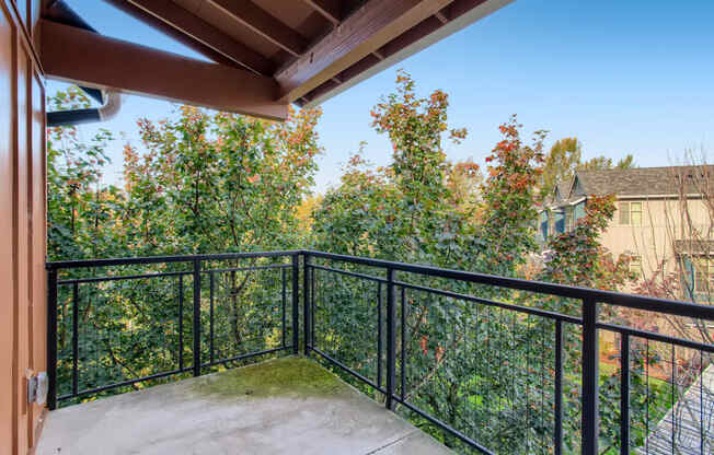 Fairview, OR Apartments - Large Covered Patio with Metal Railing and Gorgeous Landscape Views.