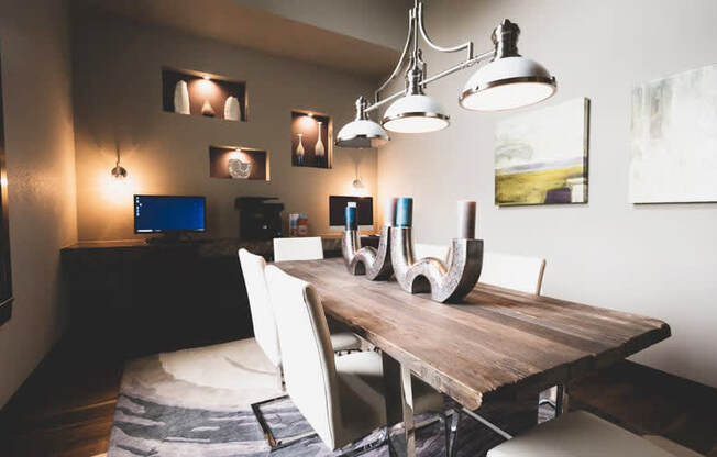 a dining room with a wooden table and white chairs