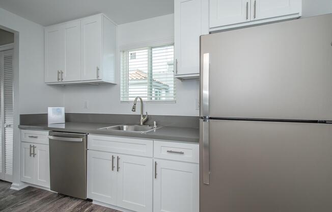a kitchen with a sink and a refrigerator