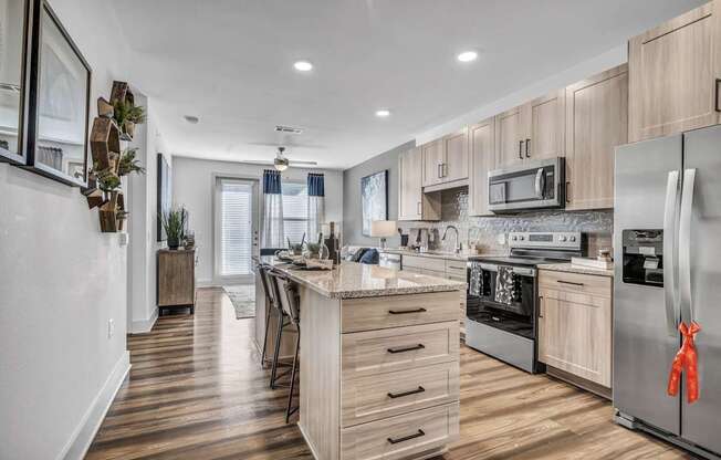 A modern kitchen with wooden cabinets and stainless steel appliances.