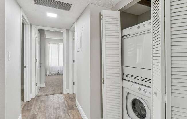 a washer and dryer in a laundry room with a closet at Summerwood Apartments, Santa Clara, 95050