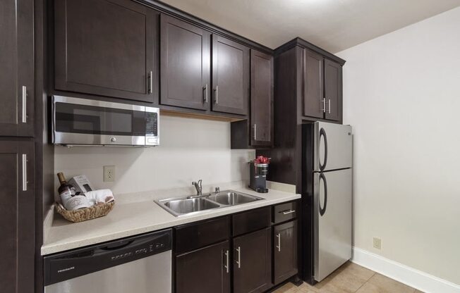 a kitchen with brown cabinets, stainless steel appliances, and a dishwasher