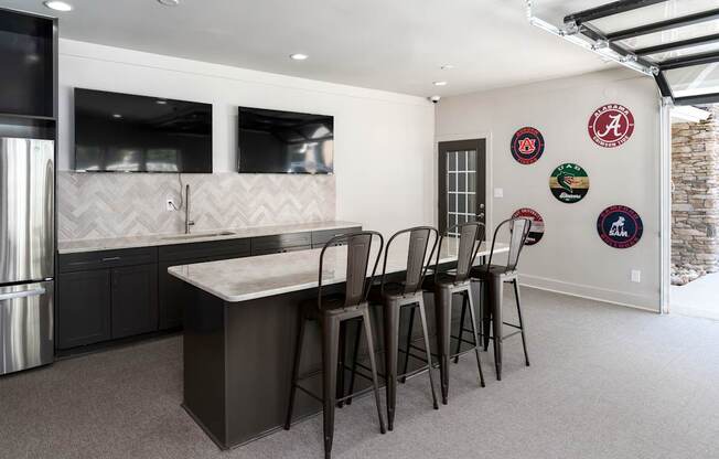 A kitchen with a table and chairs and a fridge.