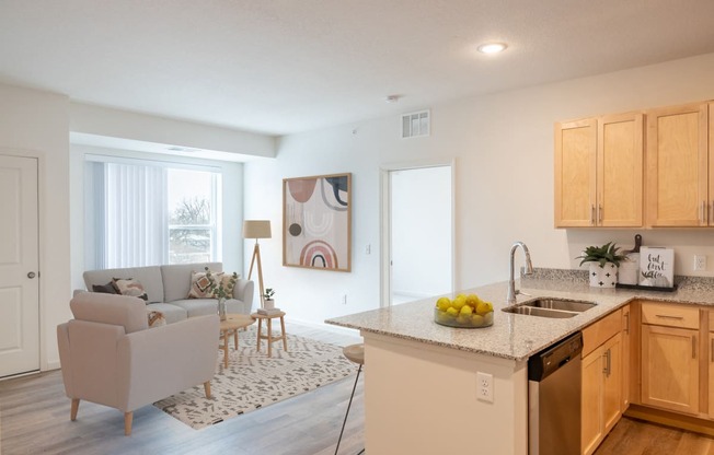 an open kitchen and living room with a couch and a table