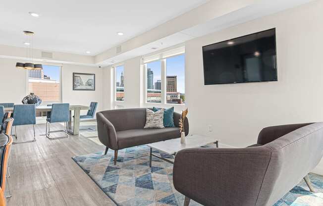 a living room with couches and chairs and a television