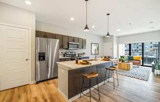 a kitchen with a large island and a stainless steel refrigerator at EagleRidge Plaza Residences, Fargo, ND, 58104