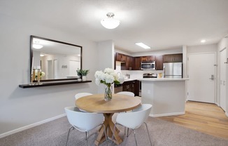 a kitchen and dining room with a table and chairs