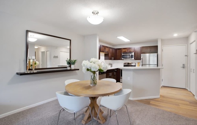 a kitchen and dining room with a table and chairs