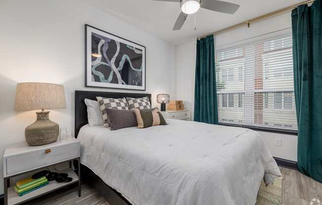 a bedroom with a large bed and a ceiling fan