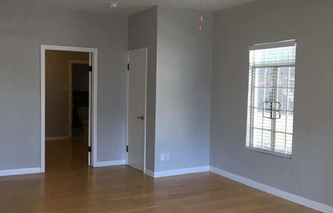 Empty living room with ceiling fan and window