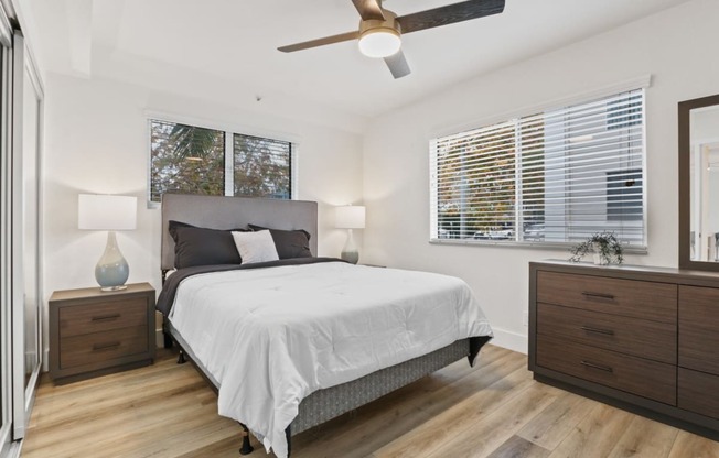 a bedroom with a bed and a ceiling fan