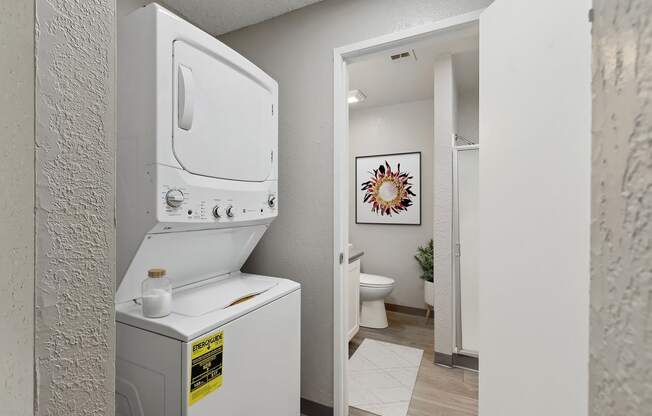 an empty laundry room with a washer and dryer in it