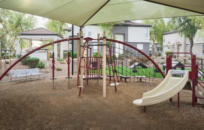 a playground with a slide and other toys in a park