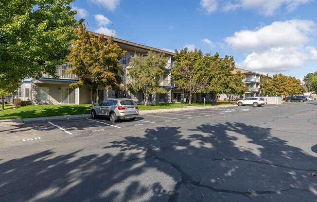 a parking lot with a car parked in front of an apartment building  at Shoreline Village, Richland, 99352