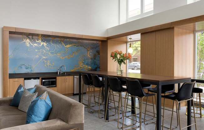A modern kitchen with a blue and gold backsplash.