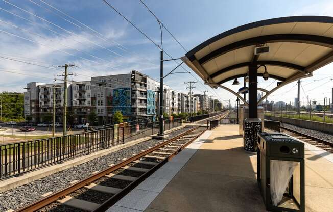 a train station with buildings in the background  at Abberly Noda Vista Apartment Homes, North Carolina, 28206