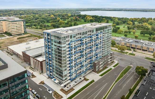 an aerial view of a tall building on the corner of a city street