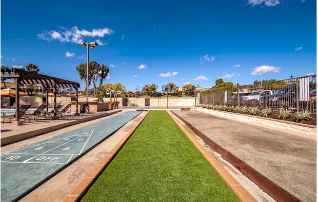 a basketball court in a park next to a road