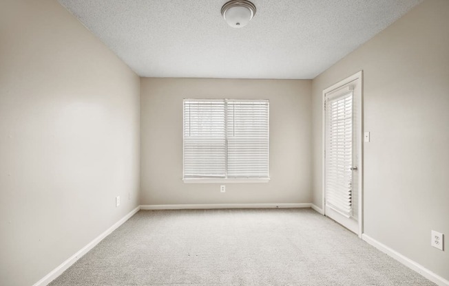 A room with a window and a door.