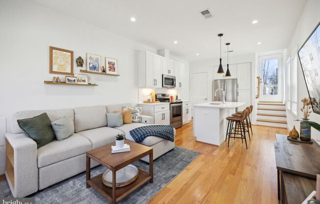 Welcome to 1181 Neal Street NE, a stunning 3-level townhome offering a private rooftop deck with breathtaking skyline views and off-street parking.