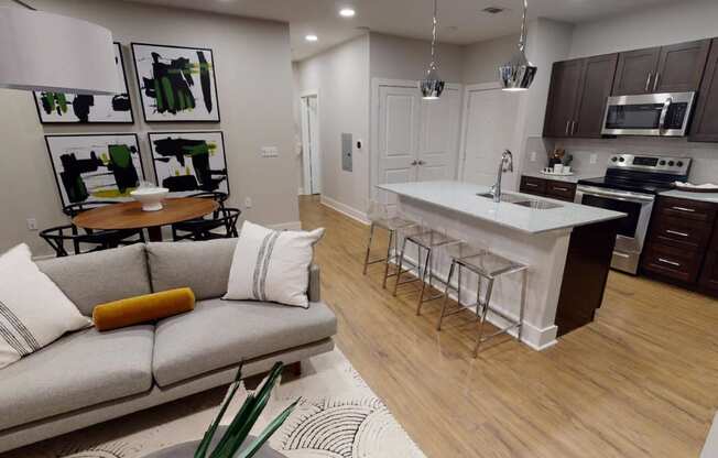 a living room with a kitchen and a couch at The Fitzroy San Marcos, San Marcos