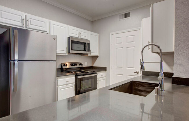 a kitchen with a sink stove and refrigerator