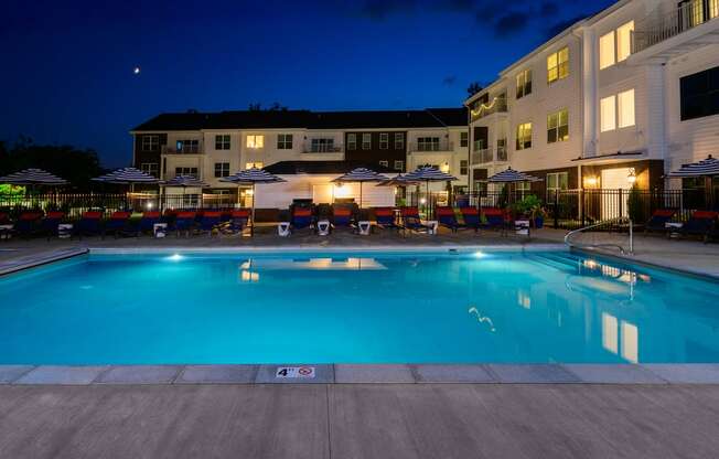 A swimming pool at a resort with a building in the background.