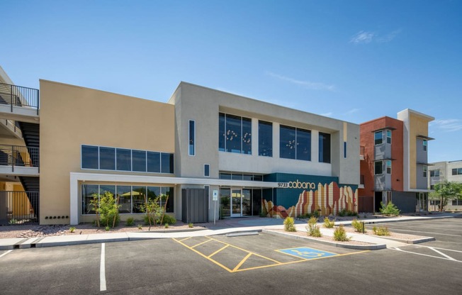 a large building with a parking lot in front of it