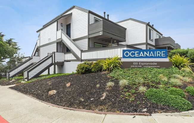 Monument sign of Oceanaire and apartment building  at OceanAire Apartment Homes, Pacifica, California