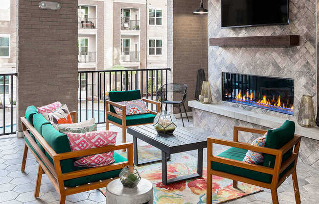 a living room with a fireplace and a balcony