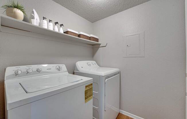 A white washing machine and dryer in a small laundry room.