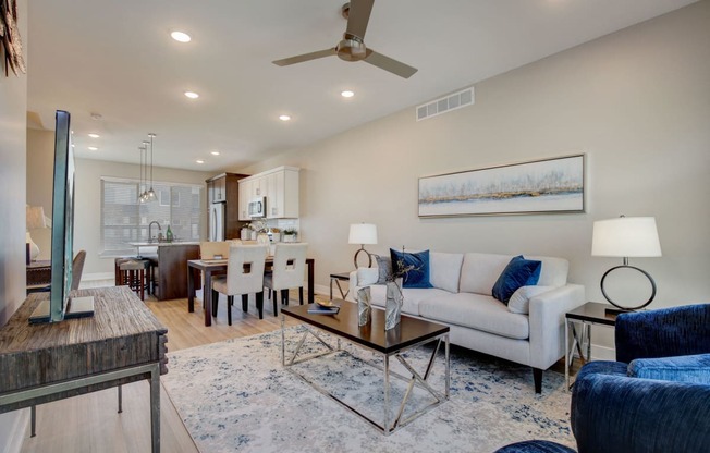 a living room with a couch and a table at  Maple Place Apartments - Southfield MI