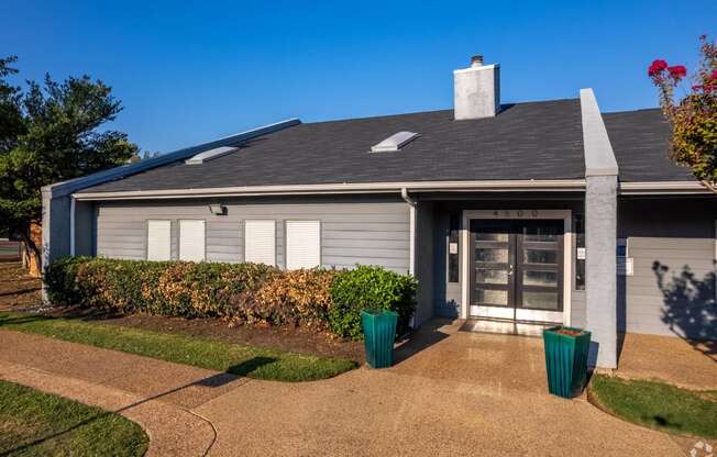 the front of a house with a driveway and a glass door