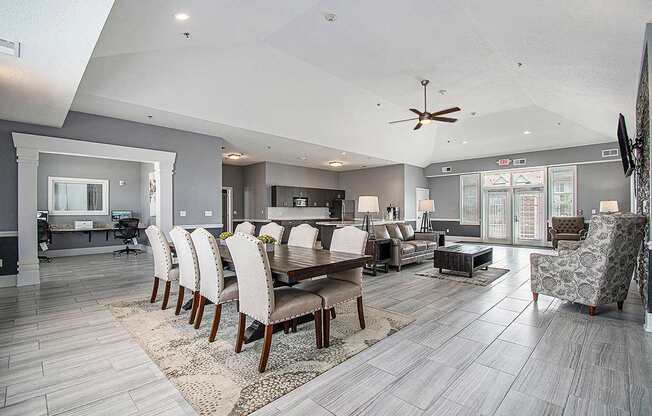 A modern community room with a large table and chairs at The Reserve at The Reserve at Destination Pointe in Grimes, IA 50111