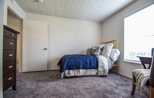 Experience comfort in this beautifully appointed bedroom featuring stylish decor and ample light.