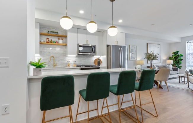 an open kitchen and living room with green bar stools at Rialto, Washington District of Columbia