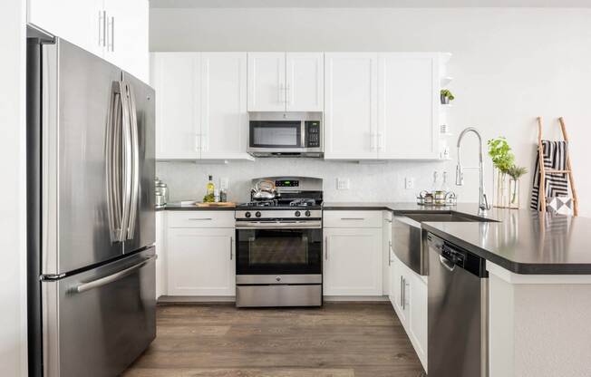 spacious kitchen with custom cabinetry and stainless appliances at Tinsley on the Park apartments