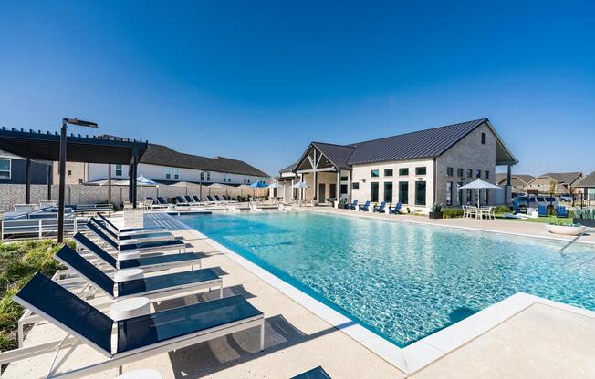 A resort-style pool at Amavi Celina features in-water loungers and generous deck space designed for relaxation.